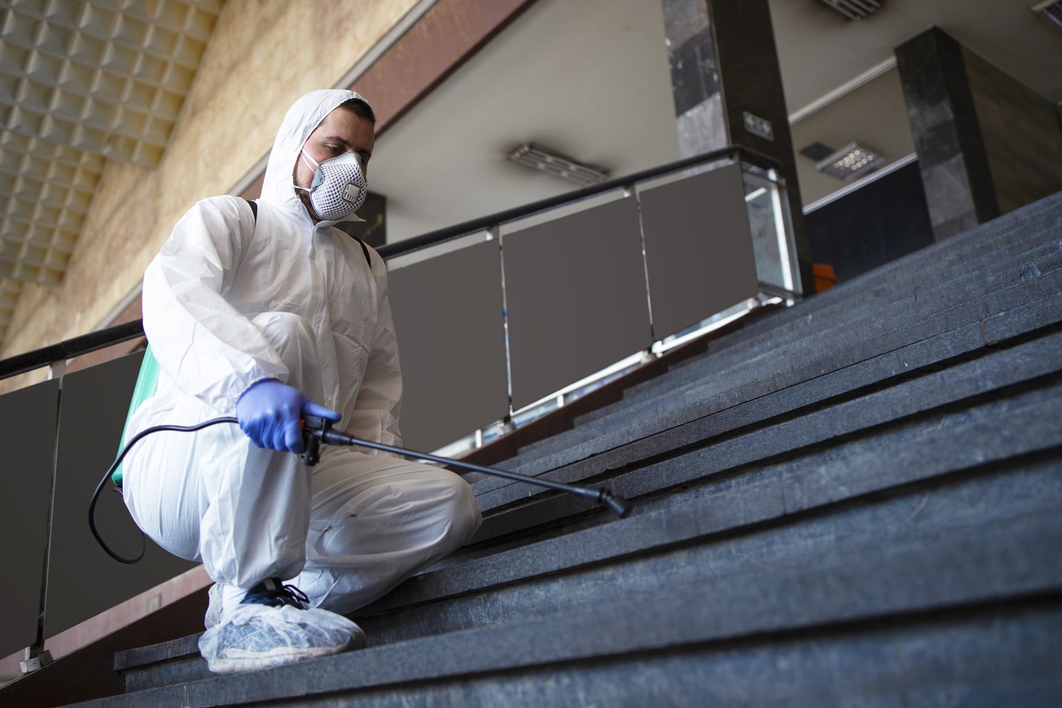 Fixins technician in protective gear applying professional odor and disinfection treatment in Colorado Springs