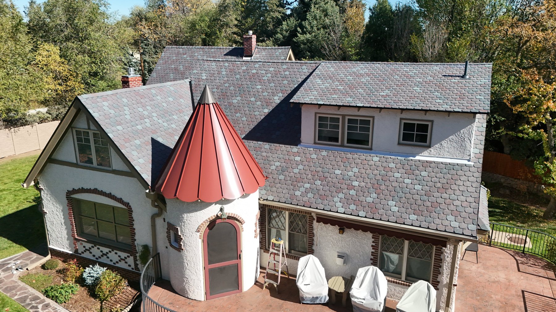 F-Wave REVIA slate-look synthetic shingle roof with copper turret on a Colorado cottage by Fixins