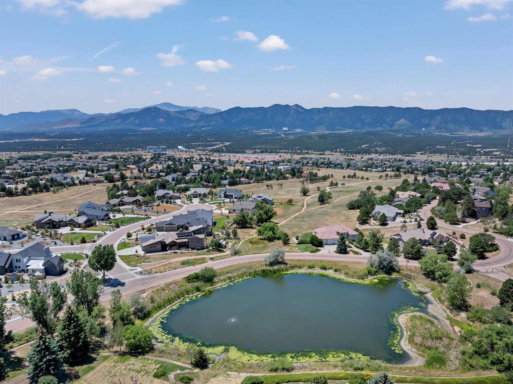 Aerial view of the Gleneagle neighborhood in Colorado Springs, with its pond and the Front Range beyond