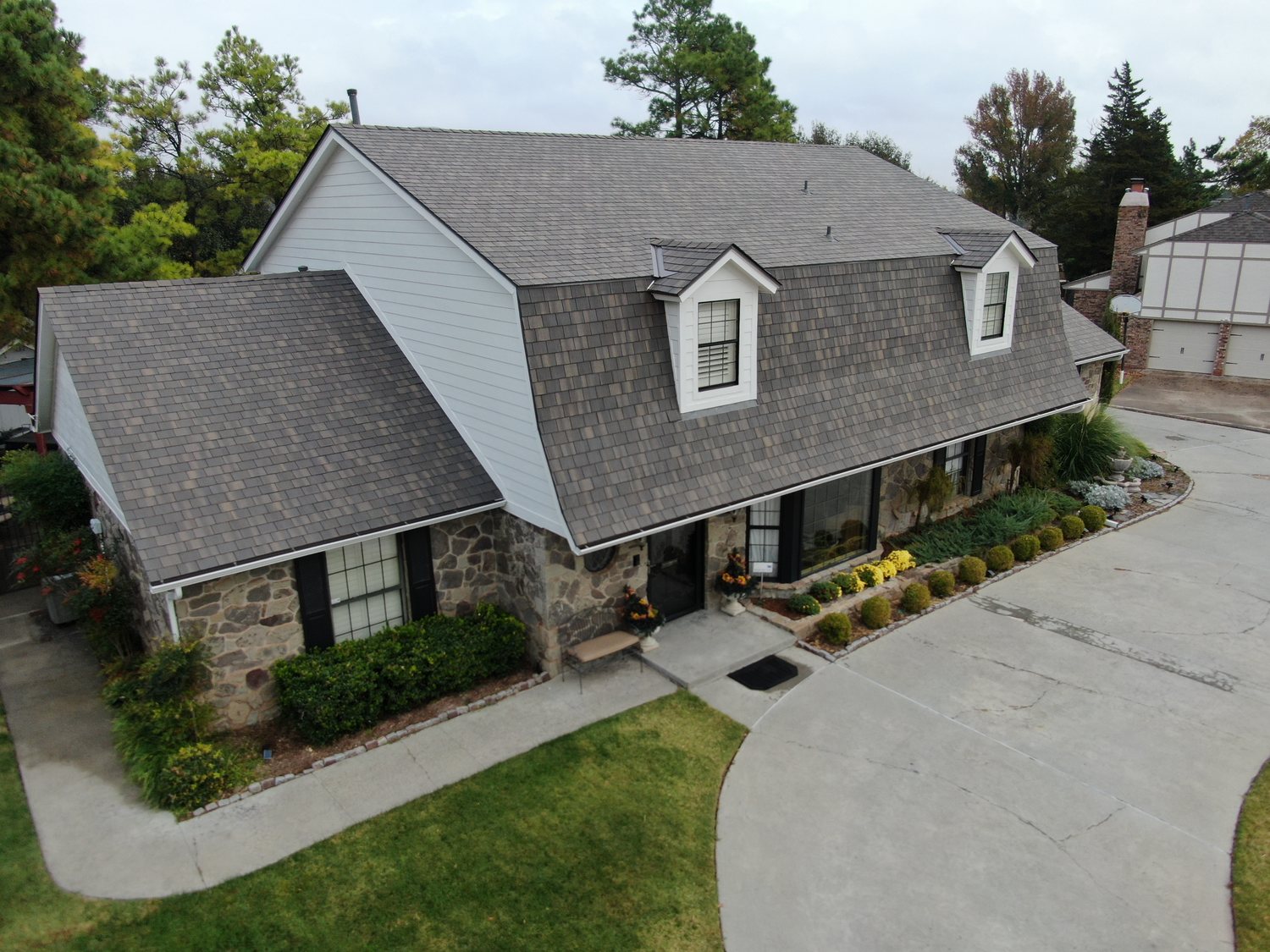New shake-profile shingle roof on a stone-and-siding home documented for an insurance claim