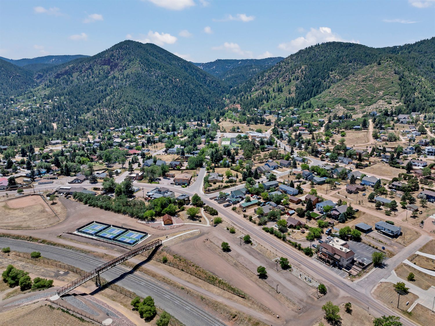 Aerial view of the town of Palmer Lake, Colorado, tucked against the forested foothills of the Front Range