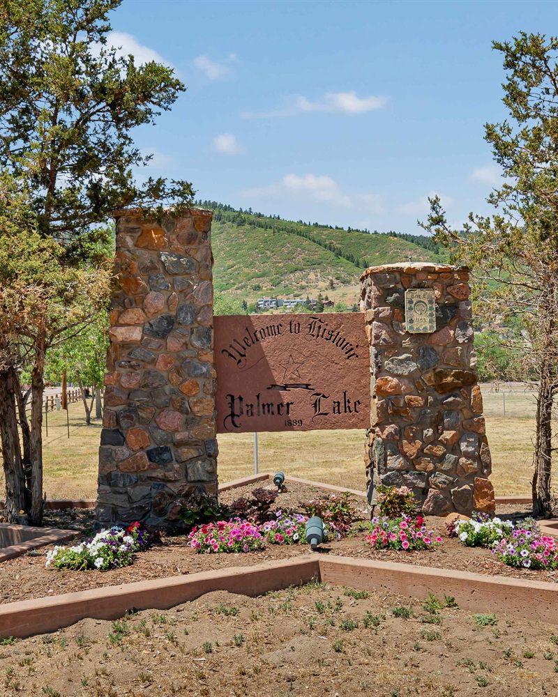 The Welcome to Historic Palmer Lake 1889 stone entrance sign in Palmer Lake, Colorado