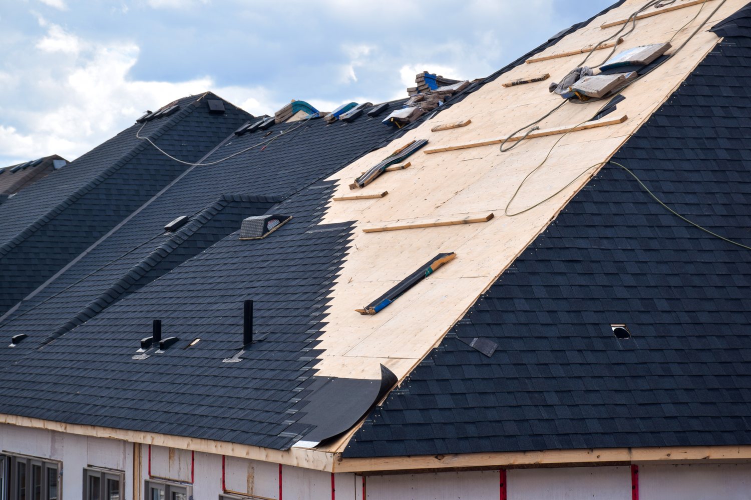 Roof tear-off in progress exposing decking during a Fixins replacement in Colorado Springs