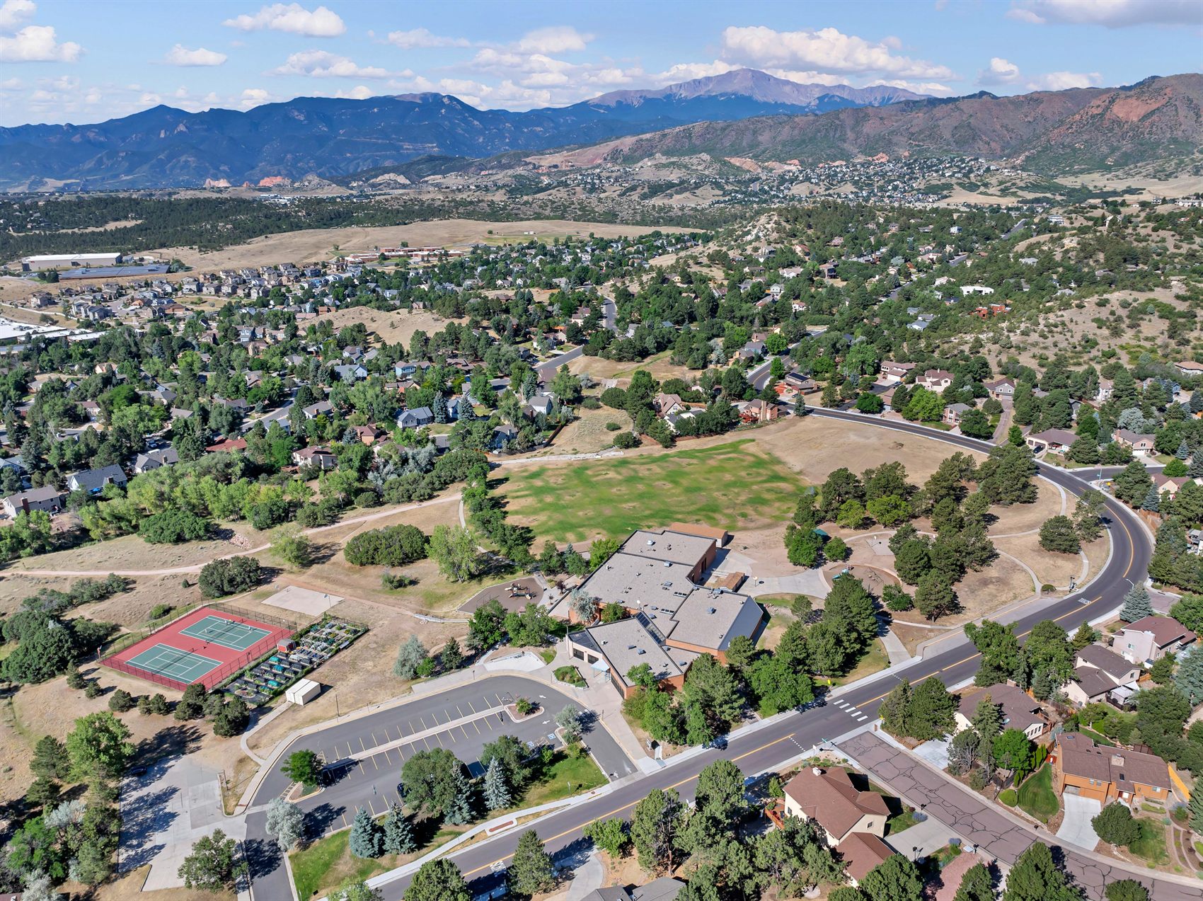 Aerial view of the Rockrimmon neighborhood in Colorado Springs, with Pikes Peak and Garden of the Gods beyond