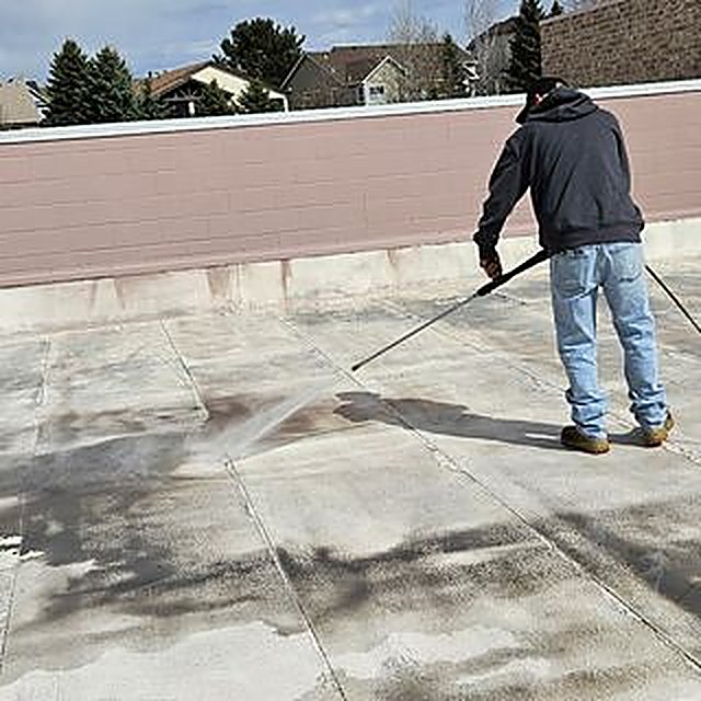 Roof coating application in progress at the Briargate YMCA in Colorado Springs