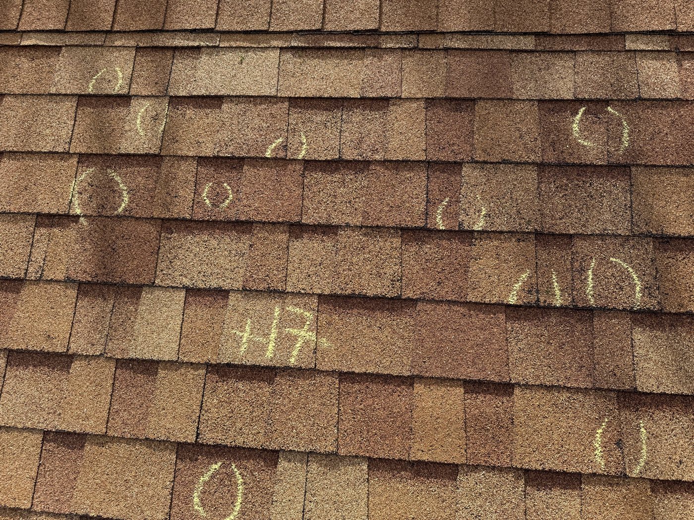 Chalk-marked hail damage documented during a Fixins roof inspection in Colorado Springs