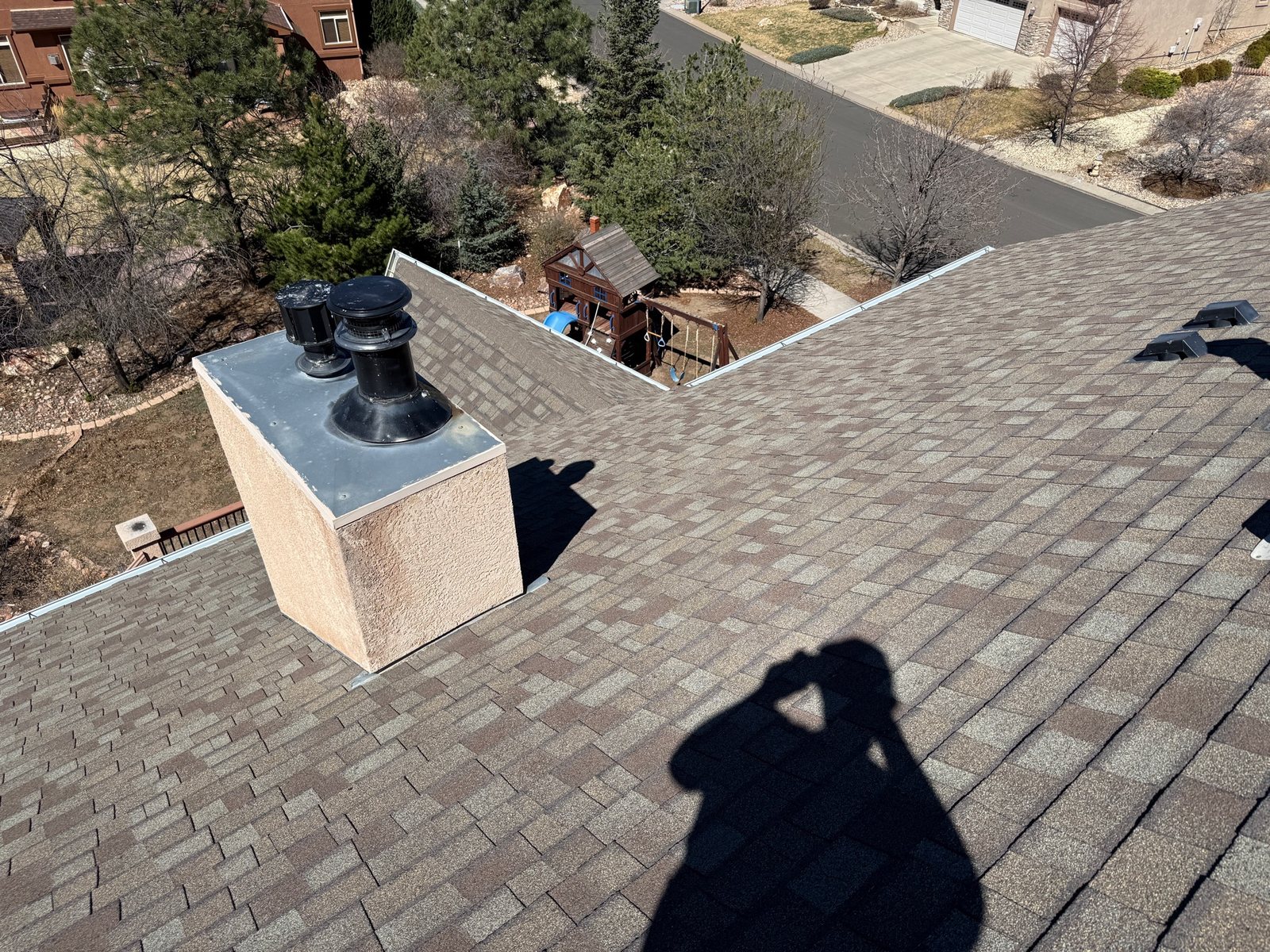 Fixins inspector examining a steep roof during a free inspection in Colorado Springs