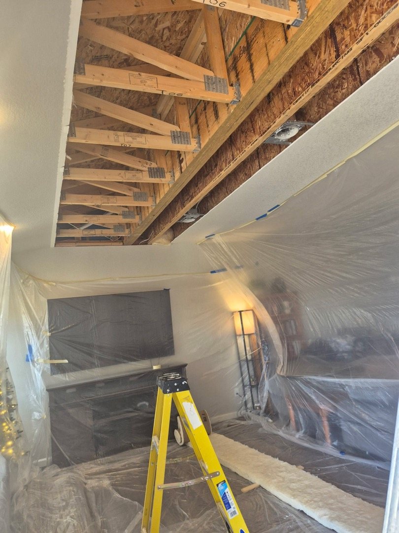 Plastic containment sheeting and exposed framing during a Fixins interior water damage restoration in Colorado Springs