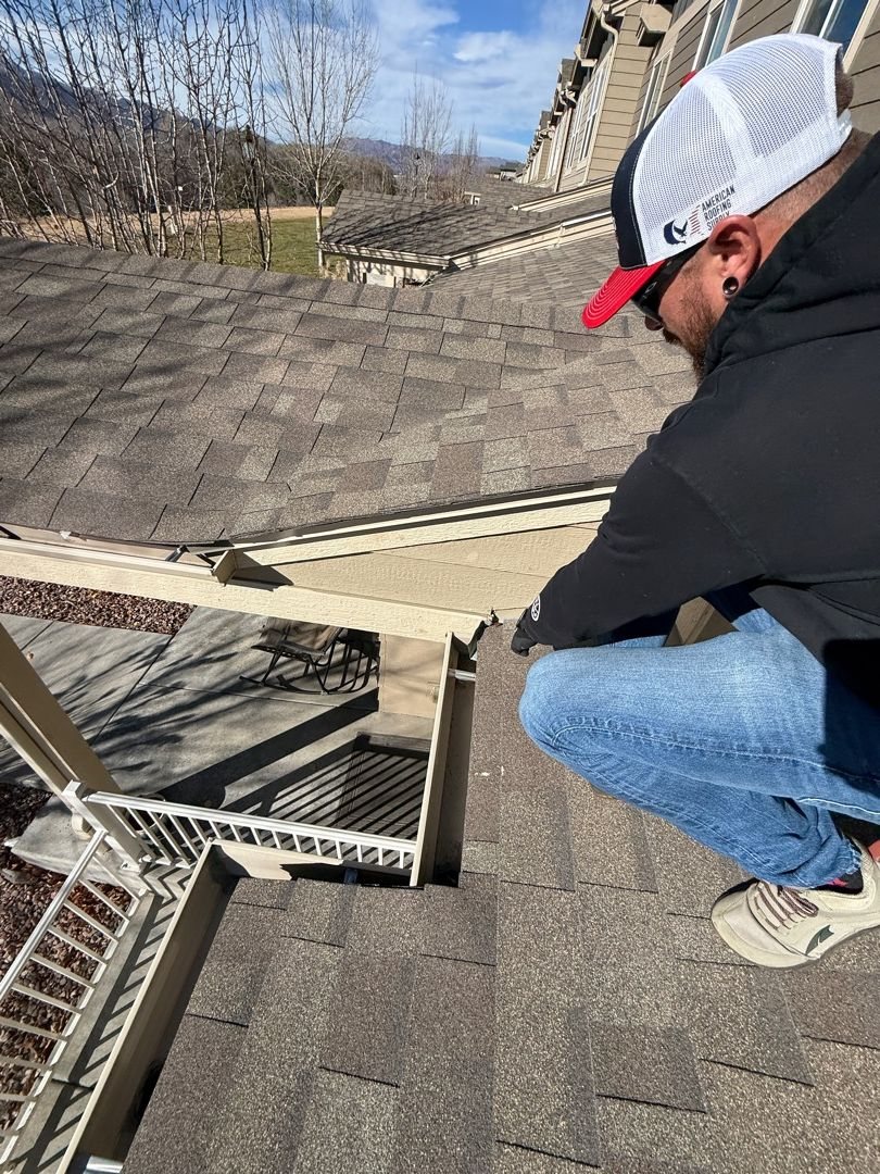 Fixins inspector tracing a roof leak at the eave of a Colorado Springs home