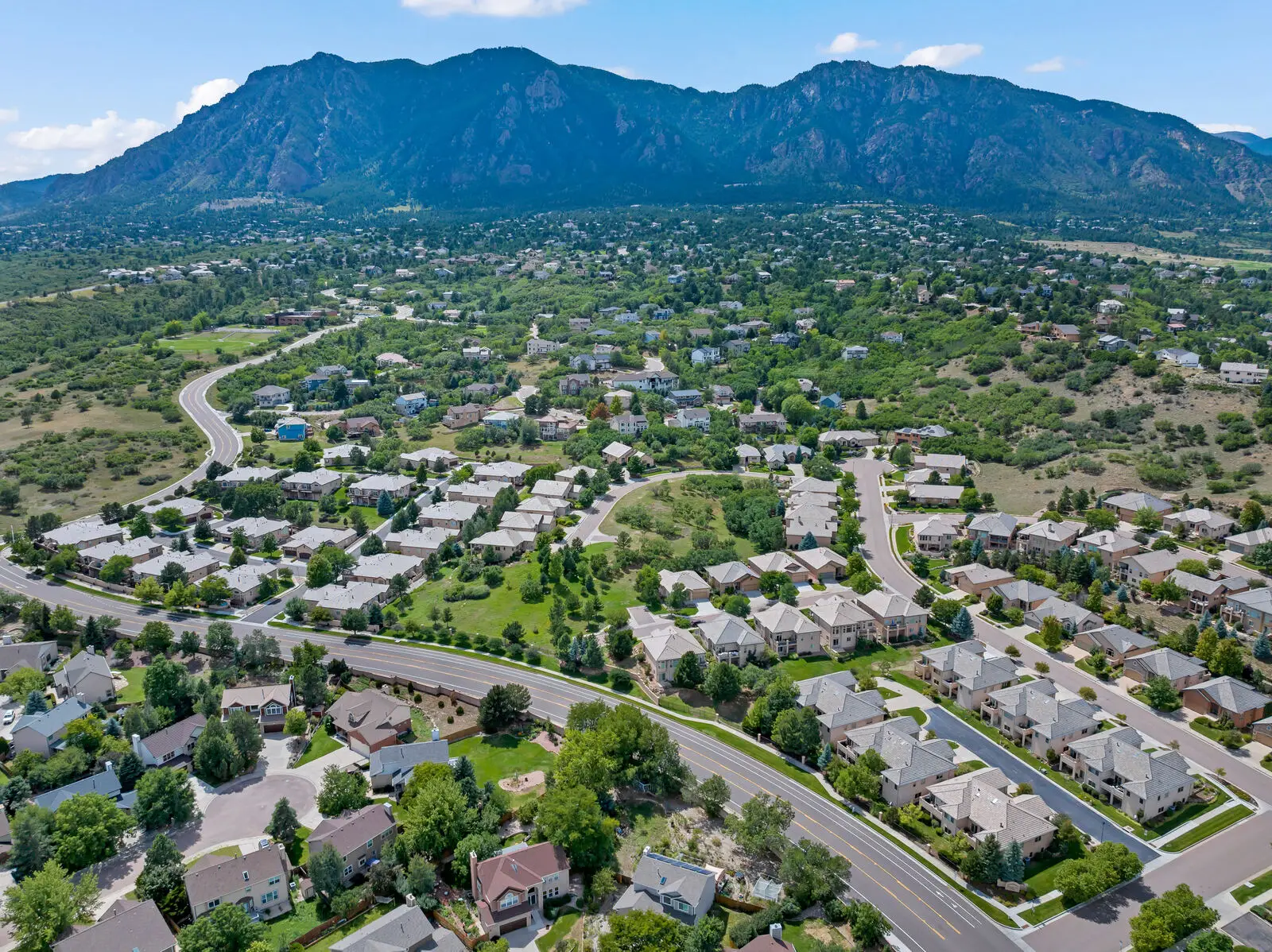 Aerial view of a Fort Carson area neighborhood in south Colorado Springs with the Cheyenne Mountain range rising behind it