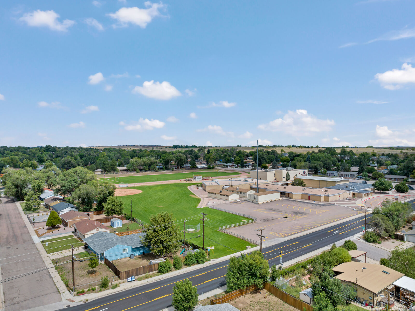 Aerial view of a Security-Widefield neighborhood beside a school athletic field in south Colorado Springs